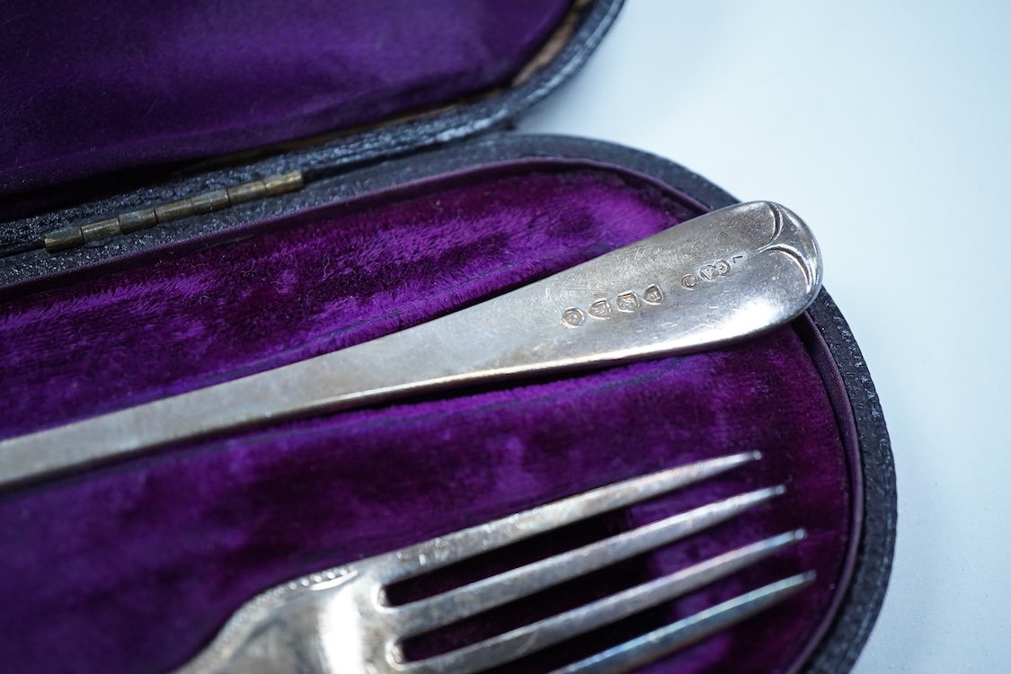 A pair of George V silver mounted dwarf candlesticks, Birmingham, 1920, height 86mm (a.f.), together with a cased Victorian silver beaded Old English pattern christening knife and fork, George Adams, London, 1881.